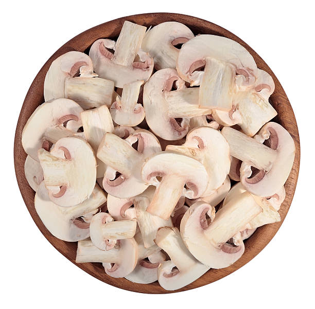 istock Sliced mushrooms in a wooden bowl on a white 537715485
