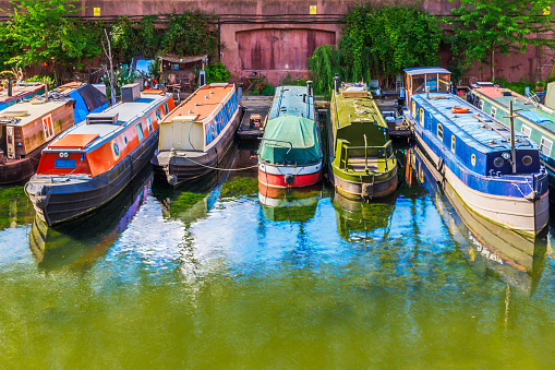 Rows of houseboats and narrow boats on the canal banks at Lisson Grove Moorings, part of the Regent's Canal in London
