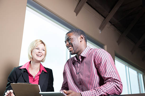istock ethnically diverse business professionals share joke in modern office 537715772