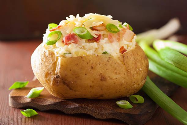 istock baked potato in jacket with bacon and cheese 537715935