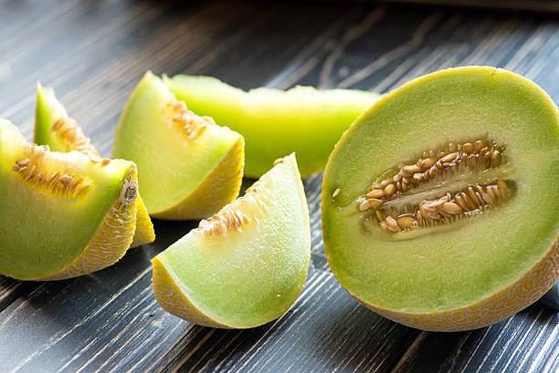 Fresh melons on wooden table Fresh melons on wooden table honeydew melon stock pictures, royalty-free photos & images