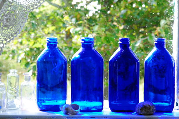 istock Antique Blue Glass Bottles on Windowsill 537716545