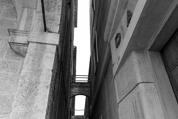 istock Narrow passage between the gloomy houses 537716725