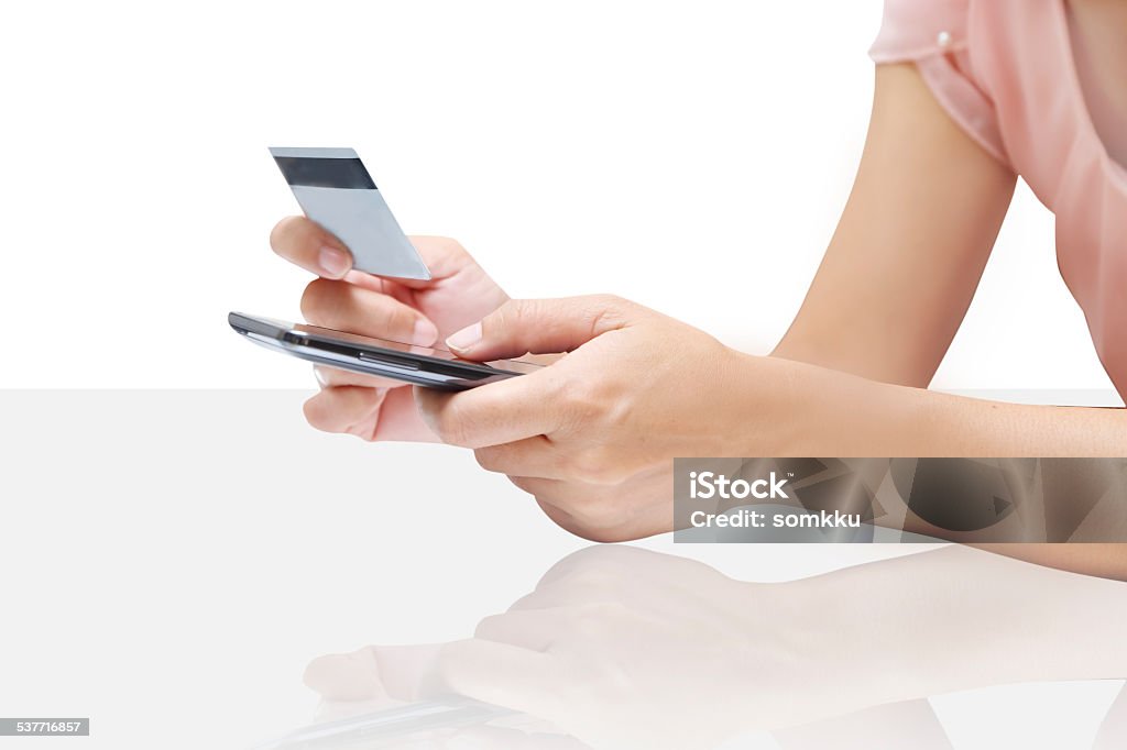 Woman shopping using credit card on white background Woman shopping using credit card 2015 Stock Photo