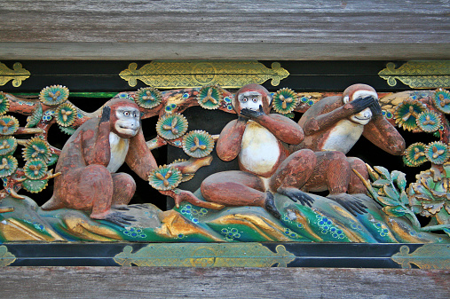 Three wise monkeys in a traditional Japanese carving. Hear no evil, speak no evil, see no evil.