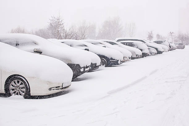 雪で覆われた車の降雪中 ストックフォト