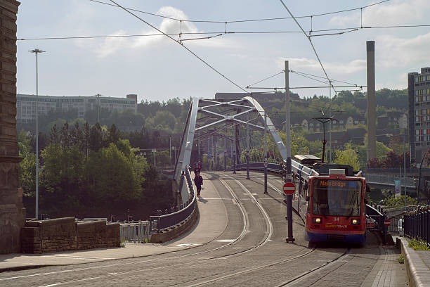 Sheffield, UK - May 19, 2016: Sheffield City Centre Urban Transport Tram.  Early morning rush hour tram crossing bridge