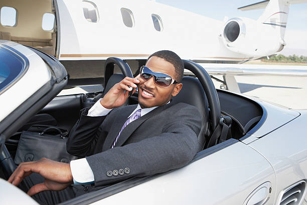 istock Businessman Using Cell Phone In Convertible 537718201