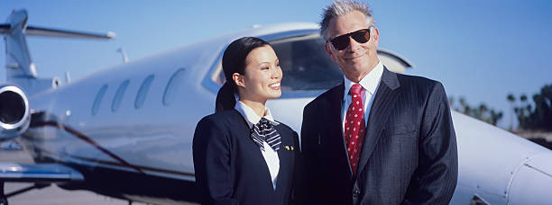 istock Businessman and Flight Crew Standing by Airplane 537718237