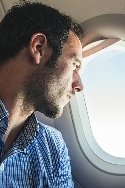 istock Tourist flying and looking out the porthole 537718635