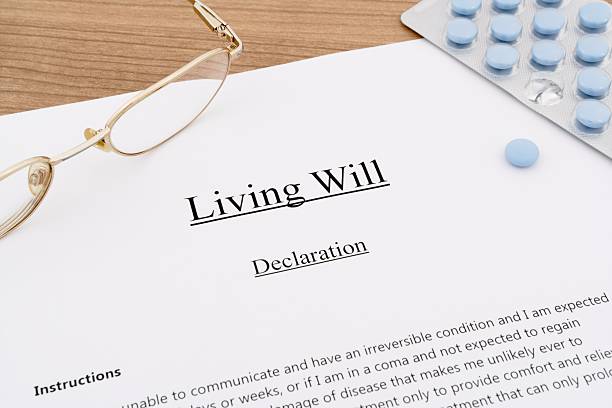 living will with pills and eyeglasses living will with pills and eyeglasses on wooden table will stock pictures, royalty-free photos & images