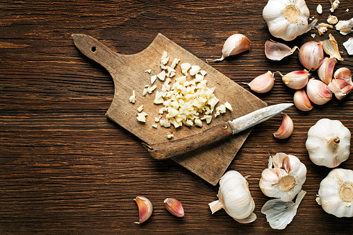 Garlic bulb and cloves on wooden table
