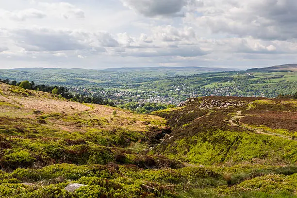 Ilkley Moor (Cow and Calf Rocks). Near Leeds, Yorkshire, England. Ilkley town is visible in the distance.