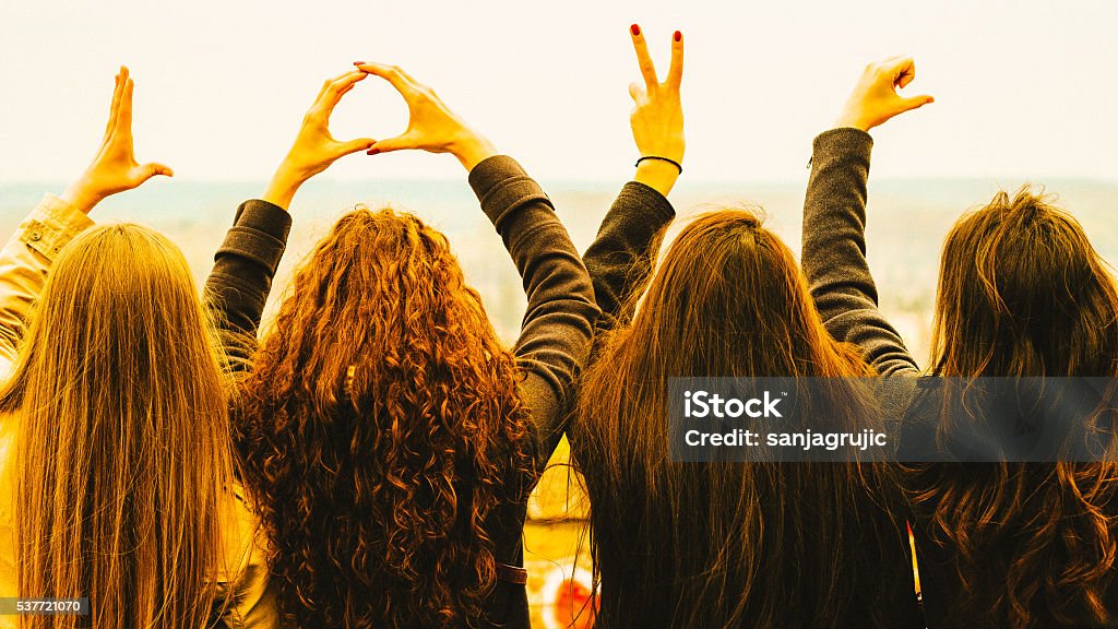 I heart you Four friends show love hands Girlfriend Stock Photo