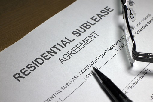 Someone filling out Residential Sublease Agreement.