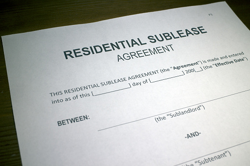 Someone filling out Residential Sublease Agreement.