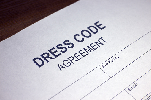 Someone filling out Dress Code Agreement.