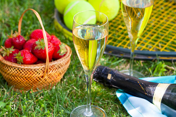 Strawberries, champagne and tennis balls stock photo