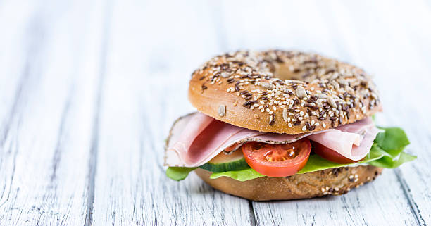 istock Wooden table with Ham Bagel (selective focus) 537728696