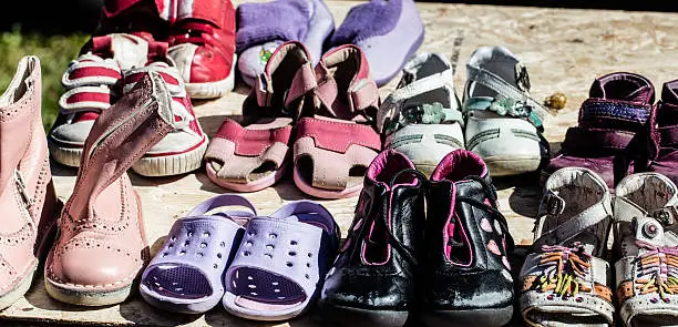 Photo of used child and baby shoes for reusing at flea market