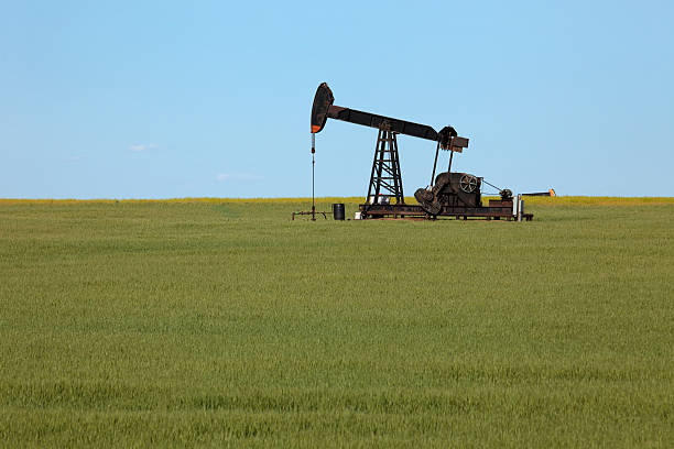 istock Old fashioned oil pump jack Kansas green agricultural fields 537729620