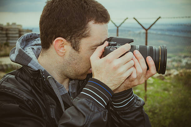 istock Photographer shooting outside with digital camera 537732636