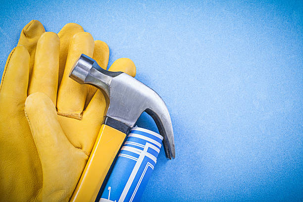istock Claw hammer safety gloves engineering drawings on blue backgroun 537732850