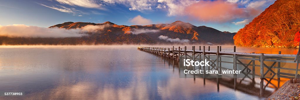 Jetty in Lake Chuzenji, Japan at sunrise in autumn Lake Chuzenji (Chuzenjiko, 中禅寺湖) near Nikko in Japan. Photographed on a beautiful still morning in autumn at sunrise. Japan Stock Photo
