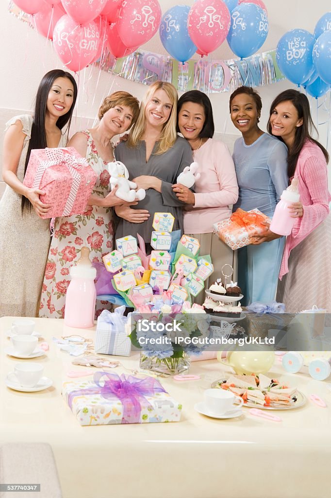 Friends at baby shower Portrait of happy pregnant woman and female friends at a baby shower 2015 Stock Photo