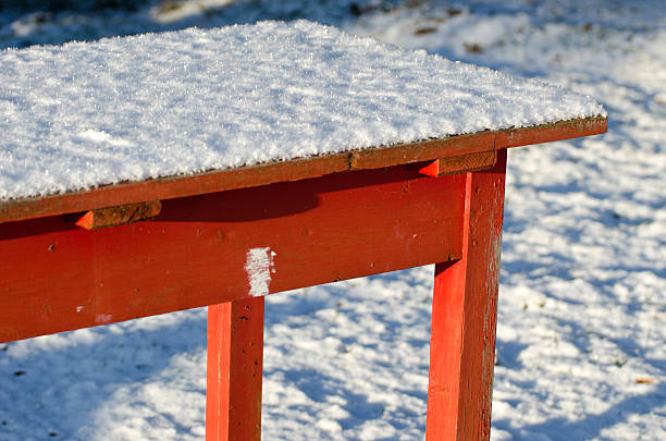 istock old red wooden garden table with snow 537741175