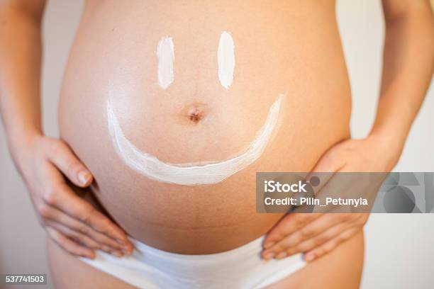 Pregnant Woman With A Smiley On Her Stomach Stock Photo - Download Image Now - 30-34 Years, Pregnant, Week