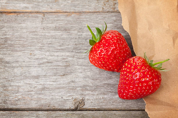 istock Ripe strawberries over wooden table background 537741801