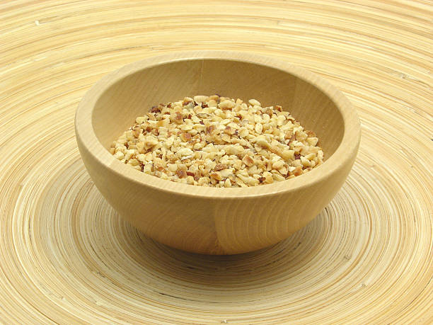 istock Wooden bowl with roasted hazelnuts on bamboo plate 537743889