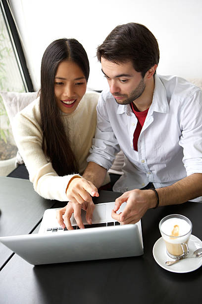 istock Two friends sitting at table with laptop 537759723