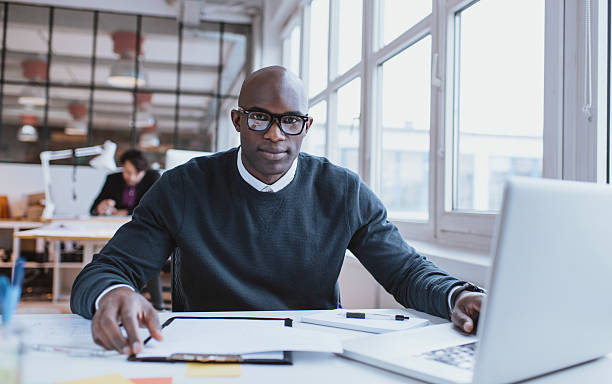istock Handsome young african man at his desk with laptop 537761493