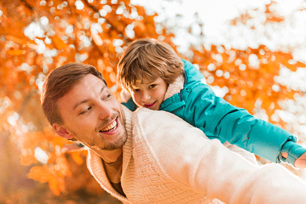 istock Playful father and son in autumn. 537763215