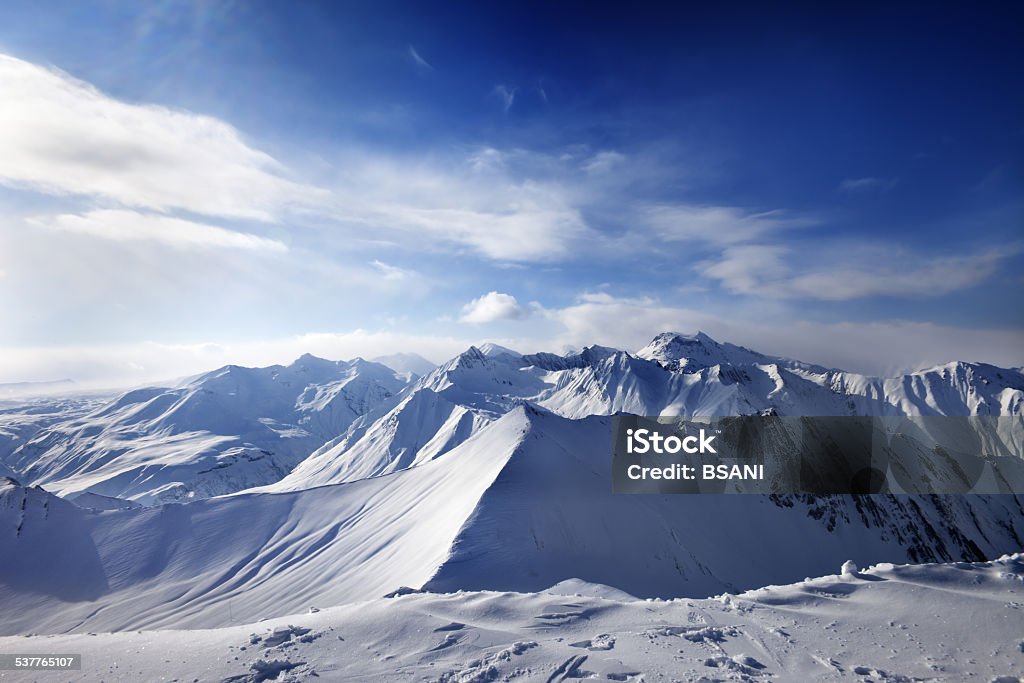 Snowy mountains and sunlight sky Snowy mountains and sunlight sky. Caucasus Mountains, Georgia, ski resort Gudauri. Wide angle view. 2015 Stock Photo