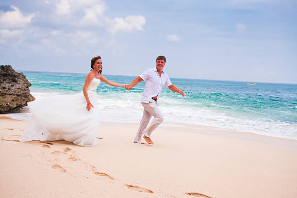 istock couple running at the beach 537765875