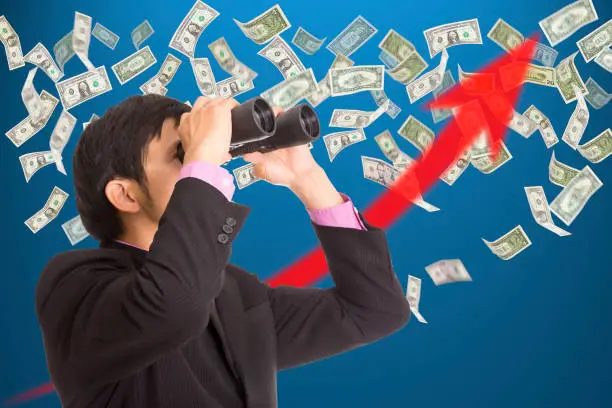 Photo of Businessman holding binoculars