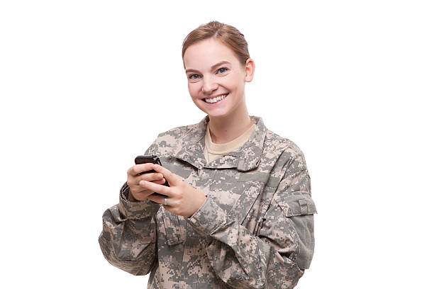 Portrait of female soldier text messaging stock photo