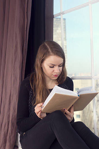 istock Woman at home and looking through the window 537790267