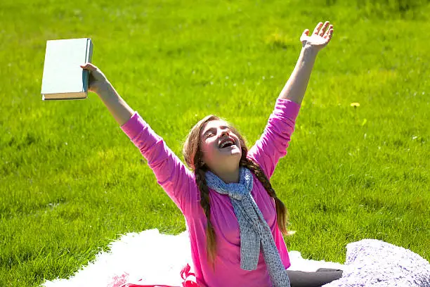 Photo of Girl smiling finishing reading book