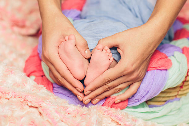 istock Baby feet in the mother hands 537792521