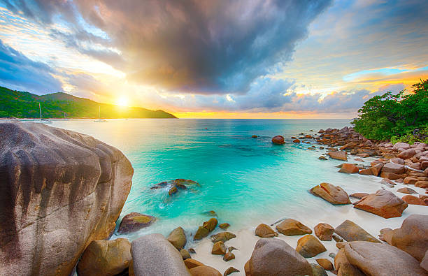 Anse Lazio Beautiful sunset over the famous beach Anse Lazio seen from the granite boulders, Praslin island, Seychelles. praslin island stock pictures, royalty-free photos & images