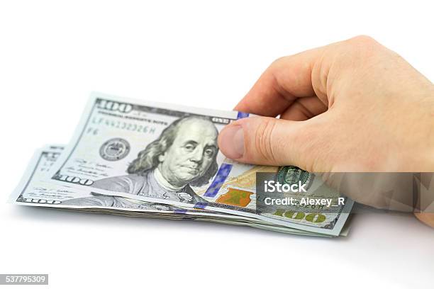 Hand Putting One Hundred Dollars Isolated On White Background Stock Photo - Download Image Now