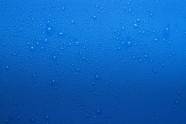 wet surface Water drops on a blue surface blue condensation stock pictures, royalty-free photos & images