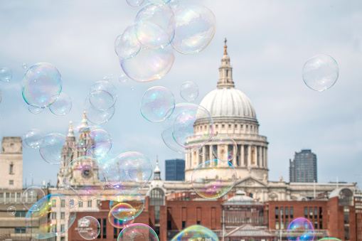 Bubbles floating in the air with St Paul's Catherdal, London in background.