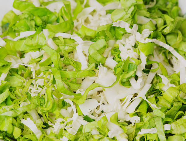 cabbage salad in a plate on a wooden table.