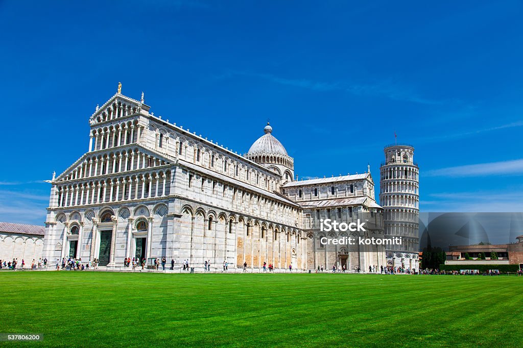 Tourists on Square of Miracles visiting Leaning Tower in Pisa, PISA, ITALY - MAY 10, 2014: Tourists on Square of Miracles visiting Leaning Tower in Pisa, Italy. Leaning Tower of Pisa is campanile and is one of the most famous buildings in the worldTourists on Square of Miracles visiting Leaning Tower in Pisa, Italy. Architecture Stock Photo