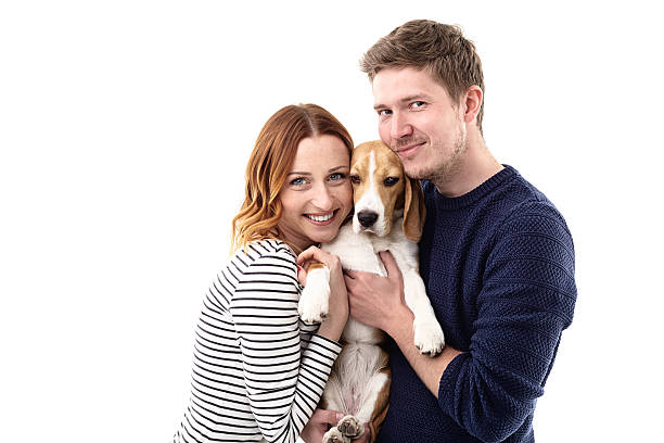 istock Cheerful young family is hugging their puppy 537807088